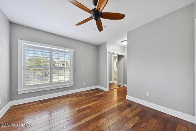 wooden floor in an empty room with a window