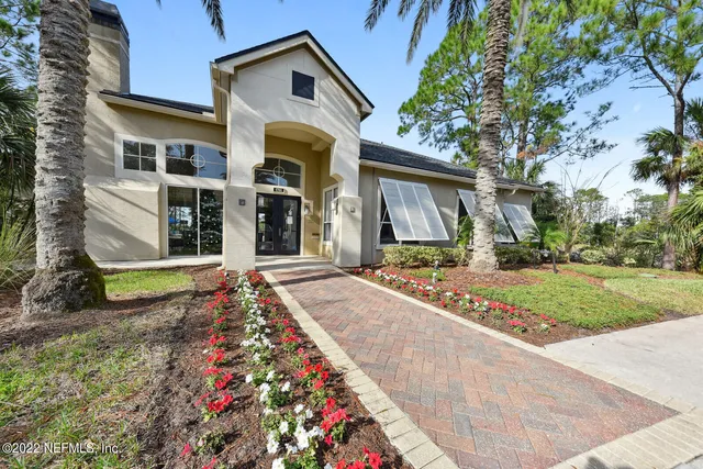 a living room with fireplace furniture and a large window
