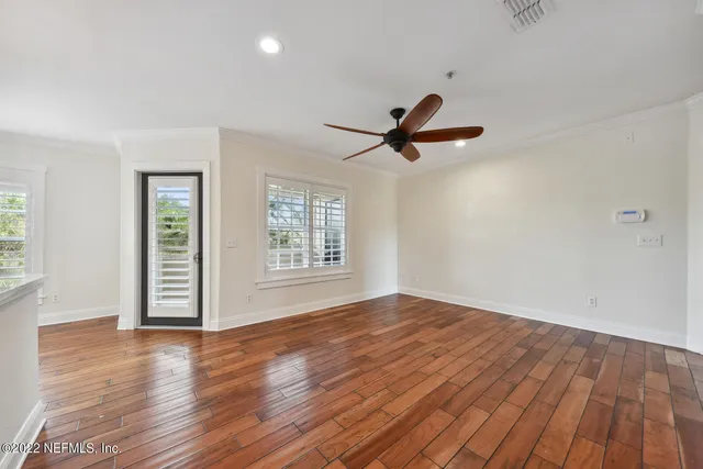 a open kitchen with white cabinets and wooden floor