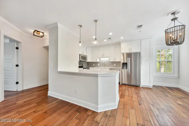 a kitchen with a refrigerator and a stove top oven