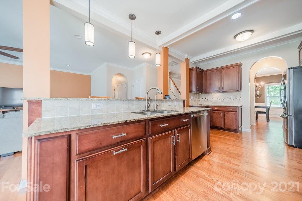 7062 Meyer Road Fort Mill, SC 29715 - Photo 12 of 46 a large kitchen with granite countertop a large counter top a sink a window and stainless steel appliances