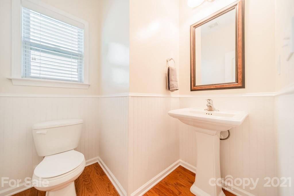 7062 Meyer Road Fort Mill, SC 29715 - Photo 17 of 46 a bathroom with a toilet sink and mirror