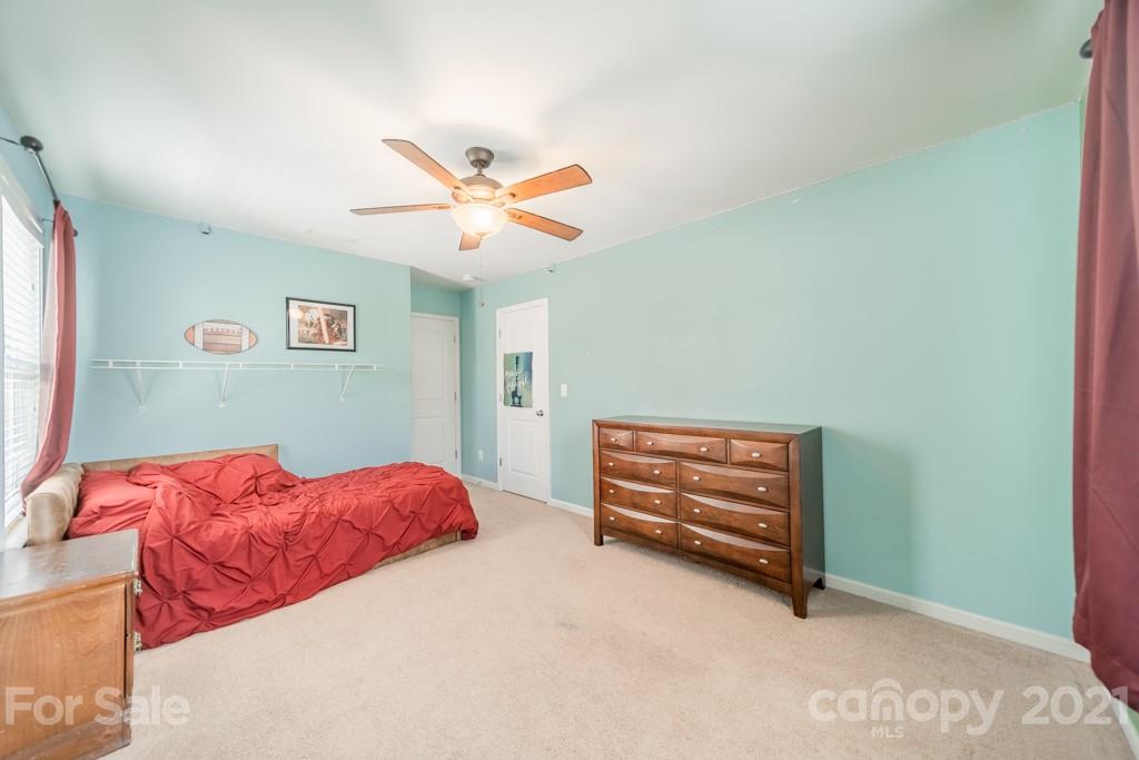 7062 Meyer Road Fort Mill, SC 29715 - Photo 24 of 46 a bedroom with a bed and a chandelier