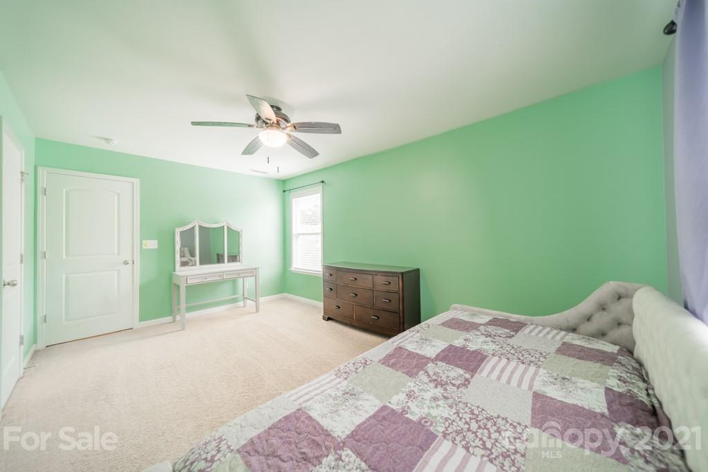 7062 Meyer Road Fort Mill, SC 29715 - Photo 25 of 46 a bedroom with a bed and a chandelier