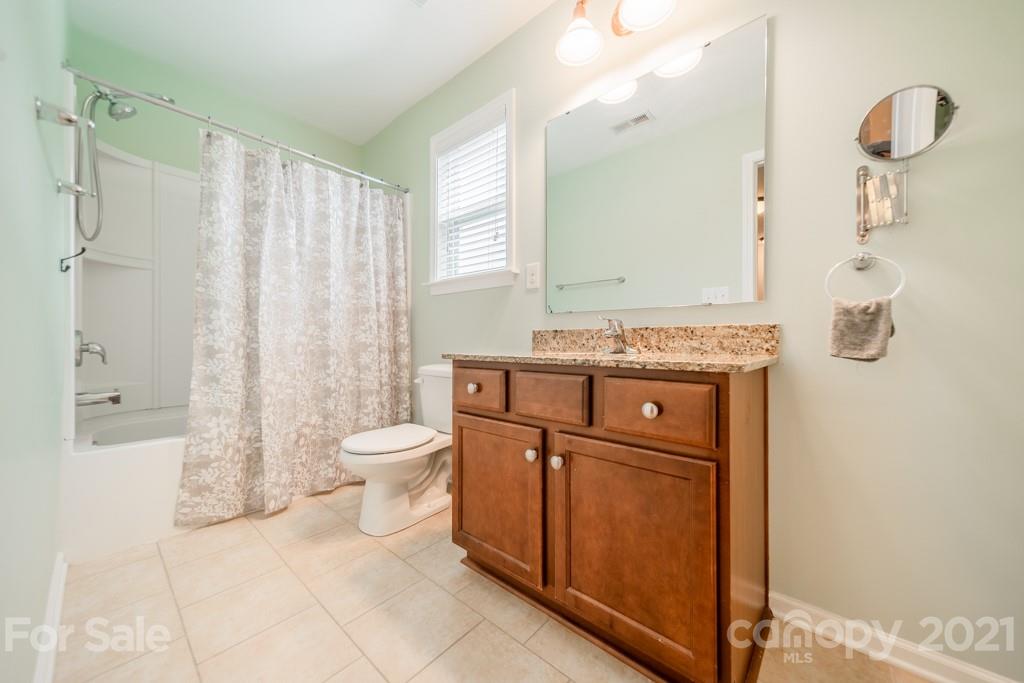7062 Meyer Road Fort Mill, SC 29715 - Photo 27 of 46 a bathroom with a granite countertop sink toilet and shower