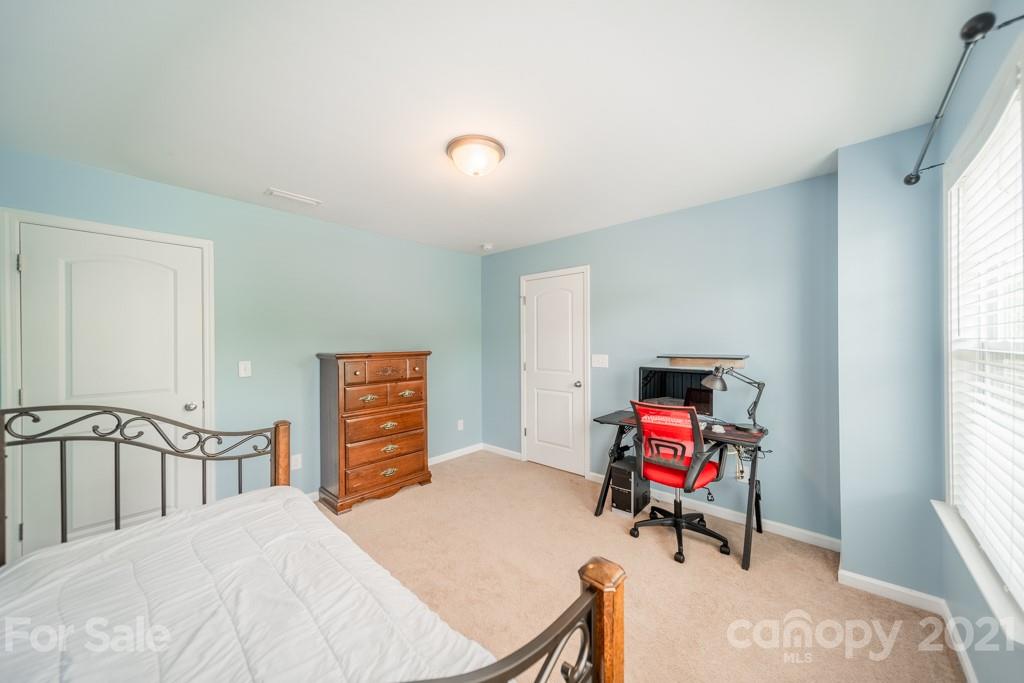 7062 Meyer Road Fort Mill, SC 29715 - Photo 28 of 46 a bedroom with a bed and a chair in it