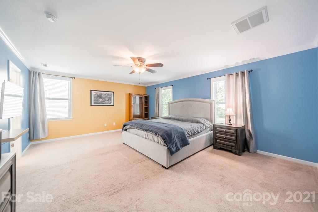 7062 Meyer Road Fort Mill, SC 29715 - Photo 29 of 46 a bedroom with a bed and a chandelier