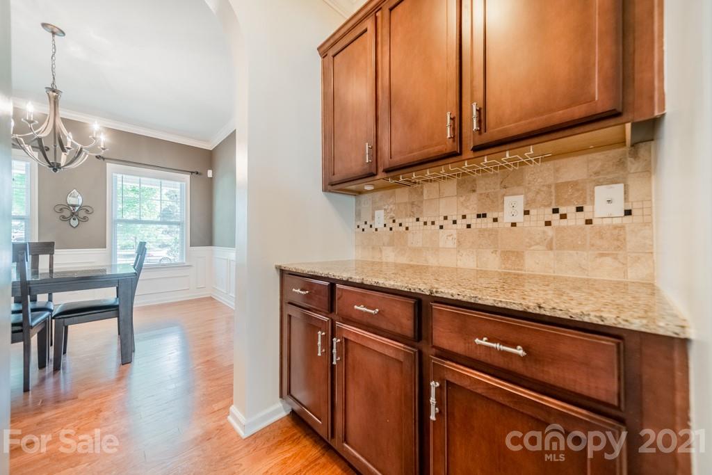 7062 Meyer Road Fort Mill, SC 29715 - Photo 7 of 46 a kitchen with granite countertop wooden cabinets a sink and dishwasher
