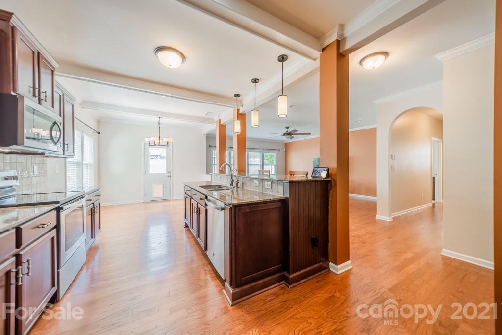 7062 Meyer Road Fort Mill, SC 29715 - Photo 8 of 46 a kitchen with stainless steel appliances granite countertop a stove and a refrigerator