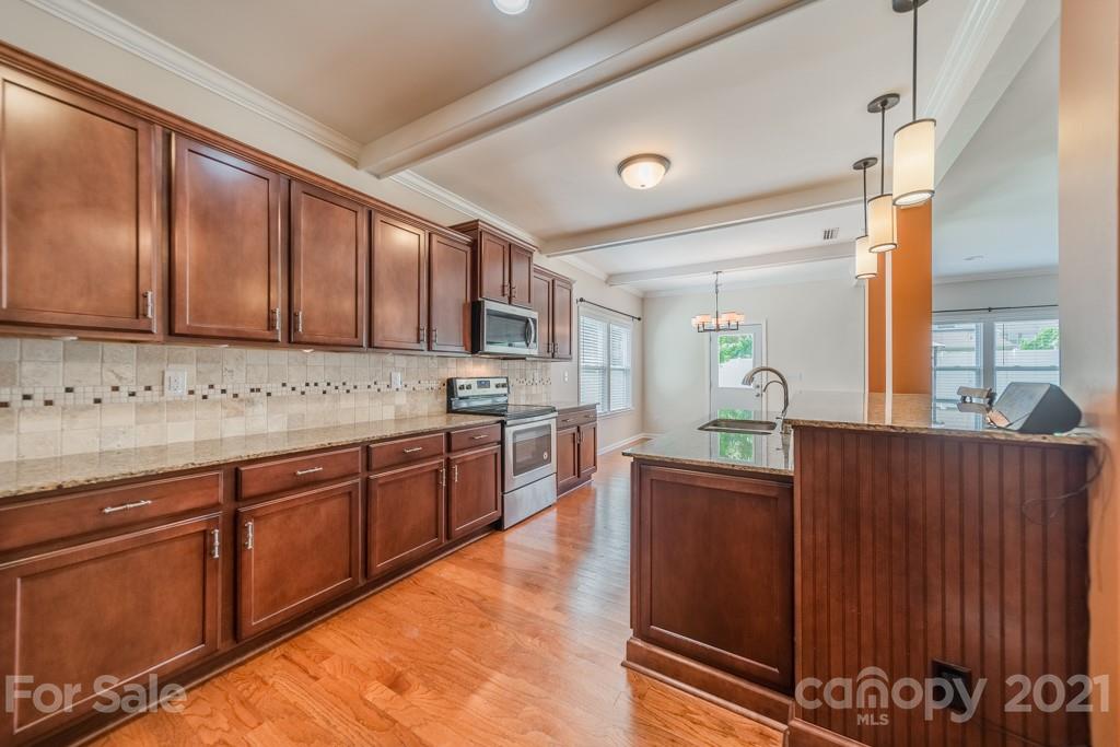 7062 Meyer Road Fort Mill, SC 29715 - Photo 10 of 46 a kitchen with stainless steel appliances granite countertop a sink stove and cabinets