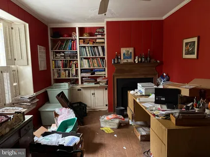 a room with furniture a bookshelf and a window