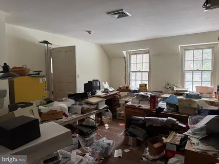 a living room with lots of furniture and a window