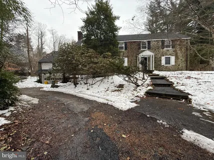 a view of a house with a yard covered in snow