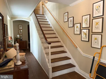 a view of entryway and hall with wooden floor