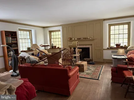 a living room with furniture fireplace and window