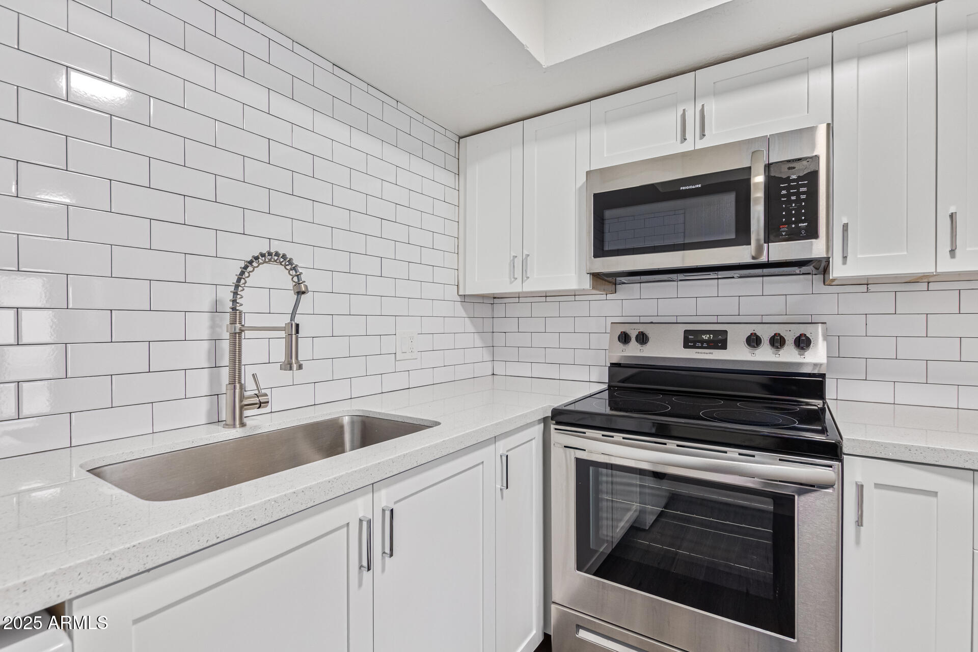2539 North 48th Street Phoenix, AZ 85008 - Photo 16 of 26 a kitchen with stainless steel appliances a stove microwave and sink