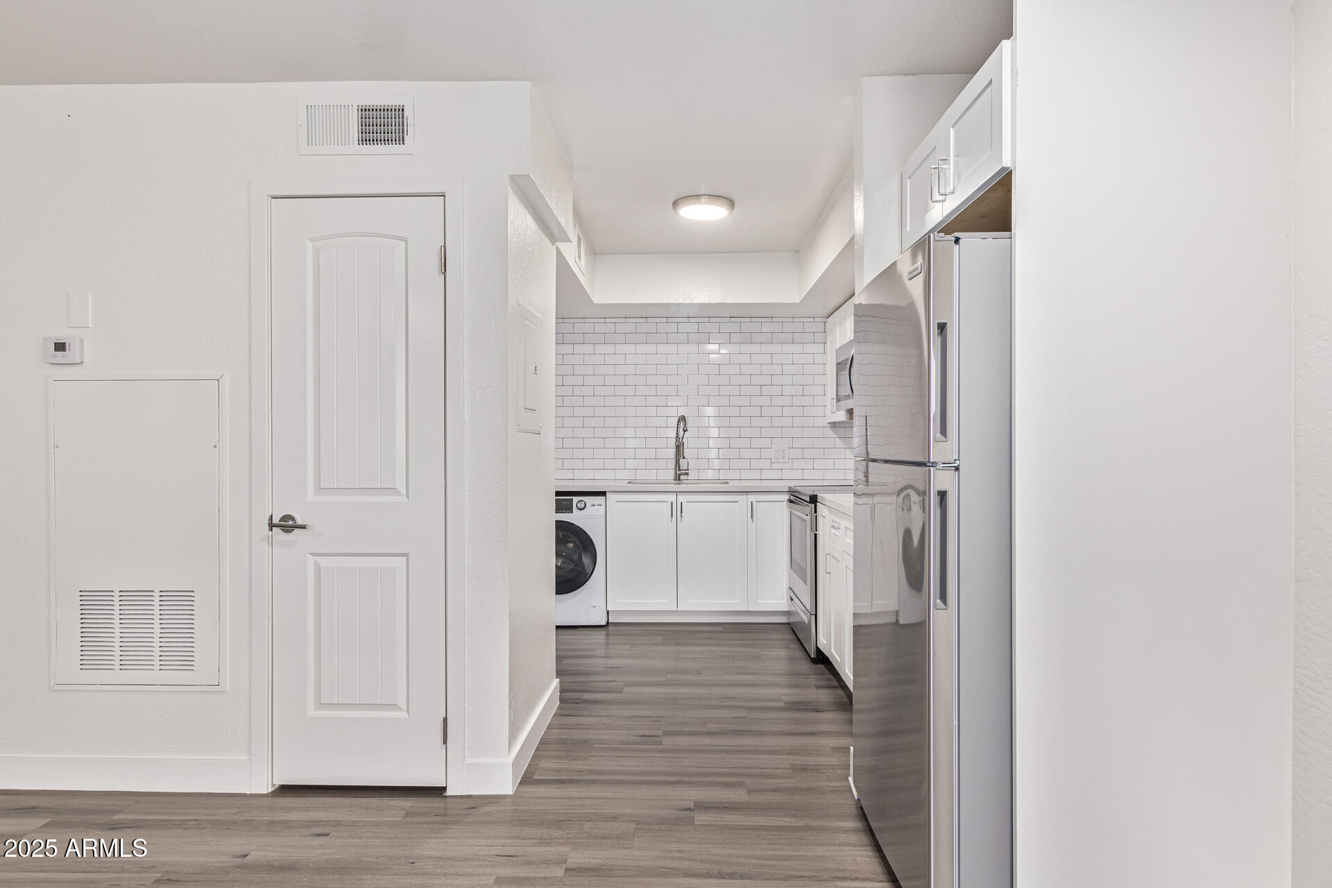 2539 North 48th Street Phoenix, AZ 85008 - Photo 21 of 26 a view of a hallway with wooden floor