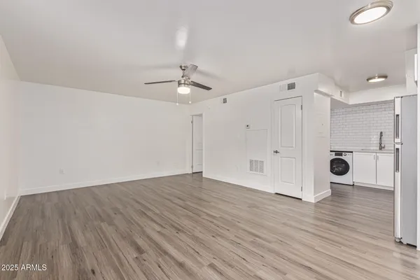 a view of an empty room with wooden floor