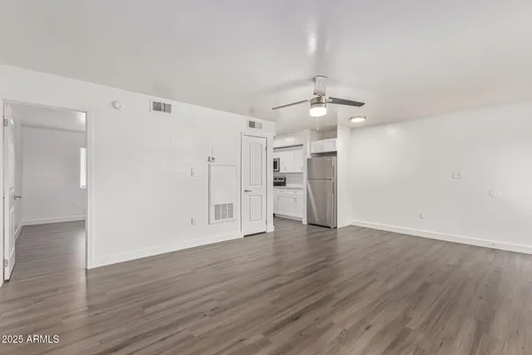 a view of an empty room with wooden floor