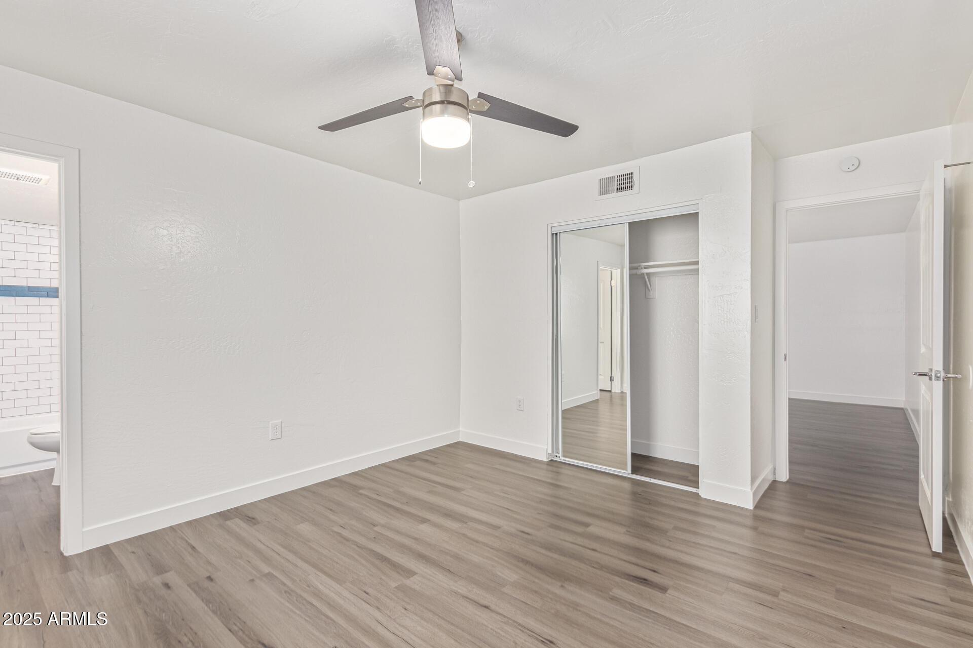 2539 North 48th Street Phoenix, AZ 85008 - Photo 25 of 26 a view of an empty room with wooden floor