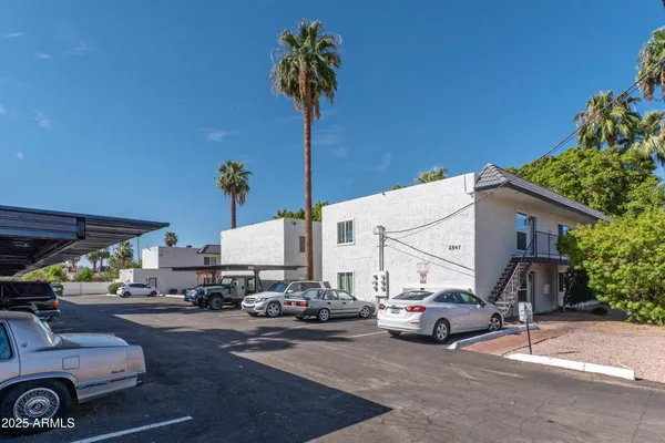 a view of a cars park in front of a building