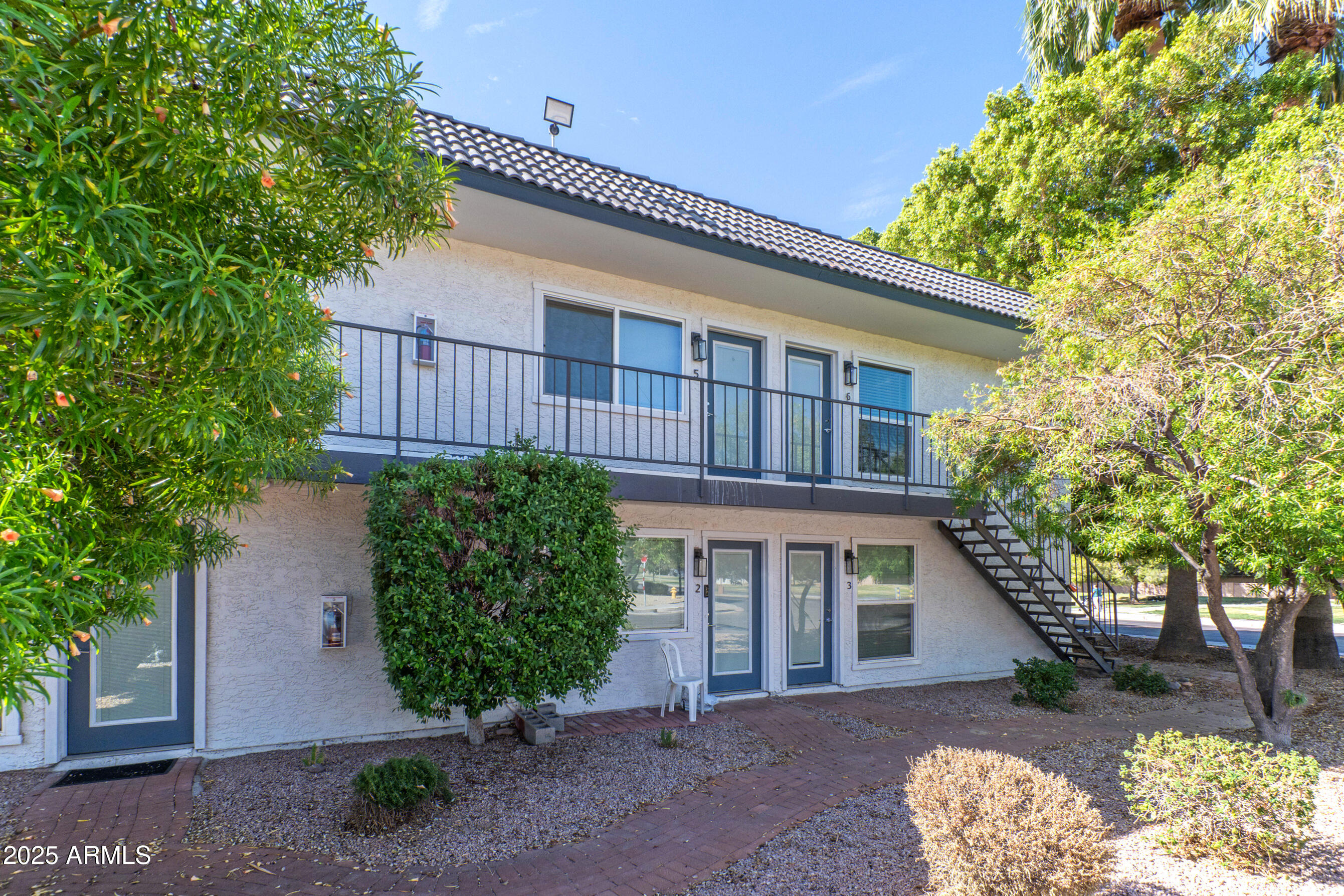 2539 North 48th Street Phoenix, AZ 85008 - Photo 6 of 26 a front view of a house with garden