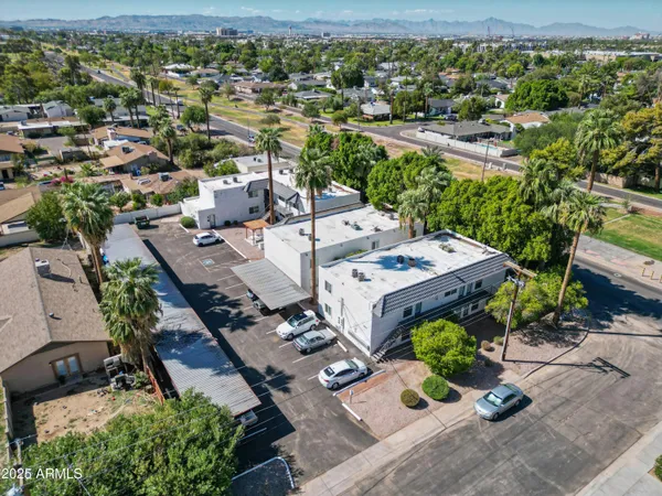 an aerial view of a house with garden space and street view