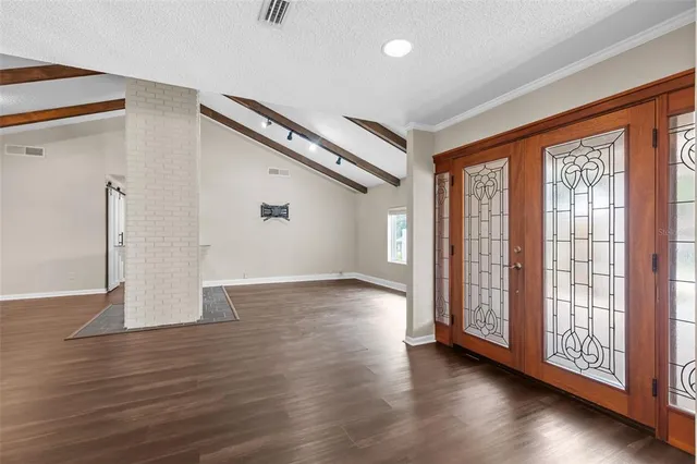 wooden floor in an empty room with a window