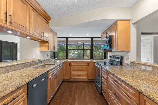 a view of a room with wooden floor and a fireplace