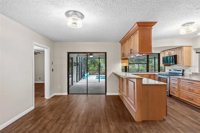 a view of a livingroom with wooden floor and a fireplace