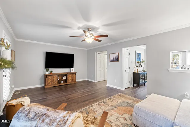 a bedroom with furniture and a flat screen tv