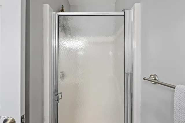 a bathroom with a glass shower door