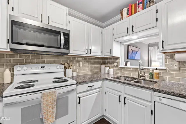 a kitchen with granite countertop cabinets stainless steel appliances and wooden cabinets