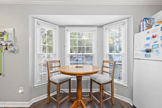 a dining room with furniture and a window