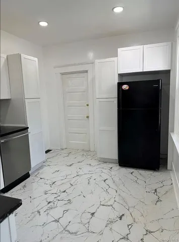 an empty room with wooden floor and entrance