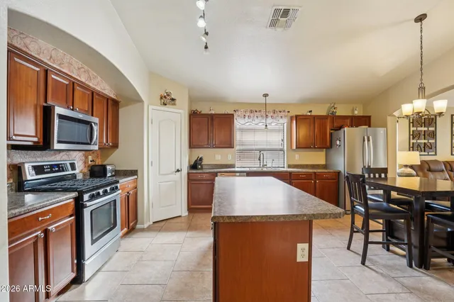a dining room with furniture a chandelier and window