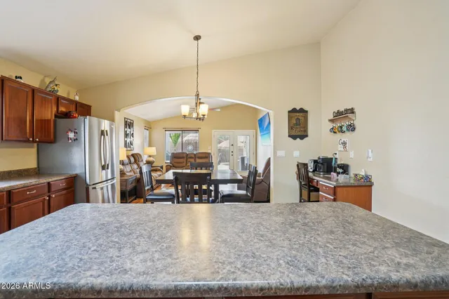 a kitchen with a stove a refrigerator and a dining table
