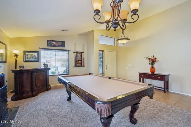 a room with pool table and windows