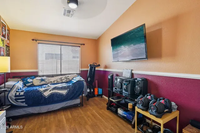 a room with a table chairs and windows