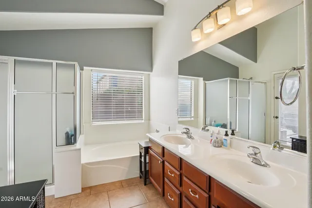 a bathroom with a tub sink and mirror