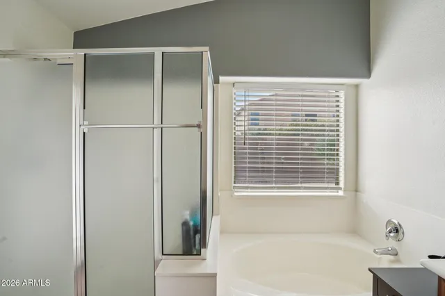 a view of walk in closet with clothes