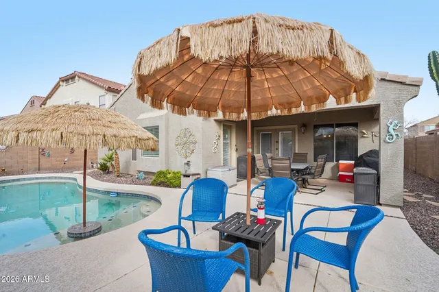 a swimming pool with outdoor seating and yard