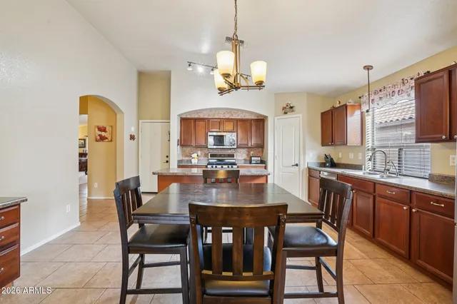 a living room with furniture a chandelier and a window