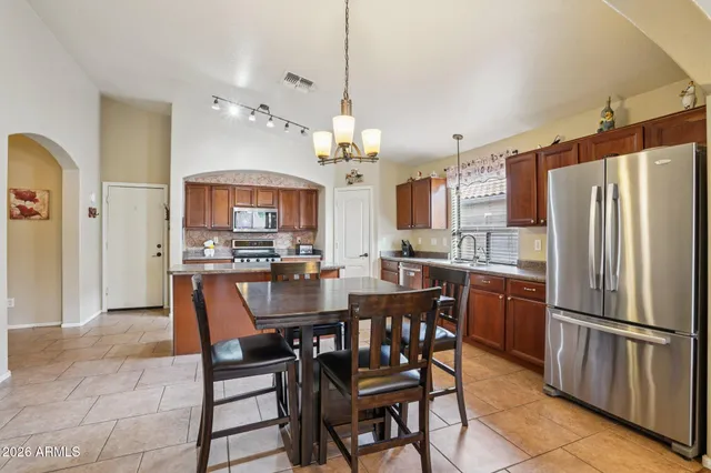 a view of a dining room with furniture and a chandelier