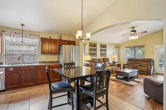 a kitchen with refrigerator a sink and chairs