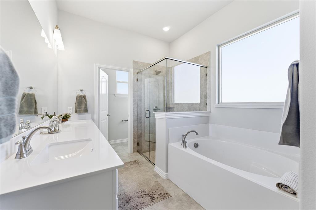 2050 County Road 200 Valley View, TX 76272 - Photo 18 of 31 Bathroom featuring a bath, double vanity, and a stall shower