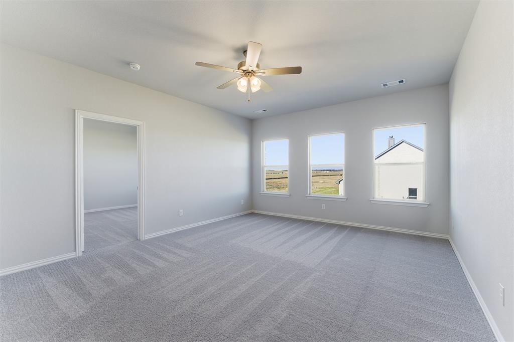 2050 County Road 200 Valley View, TX 76272 - Photo 23 of 31 Carpeted empty room featuring baseboards and a ceiling fan