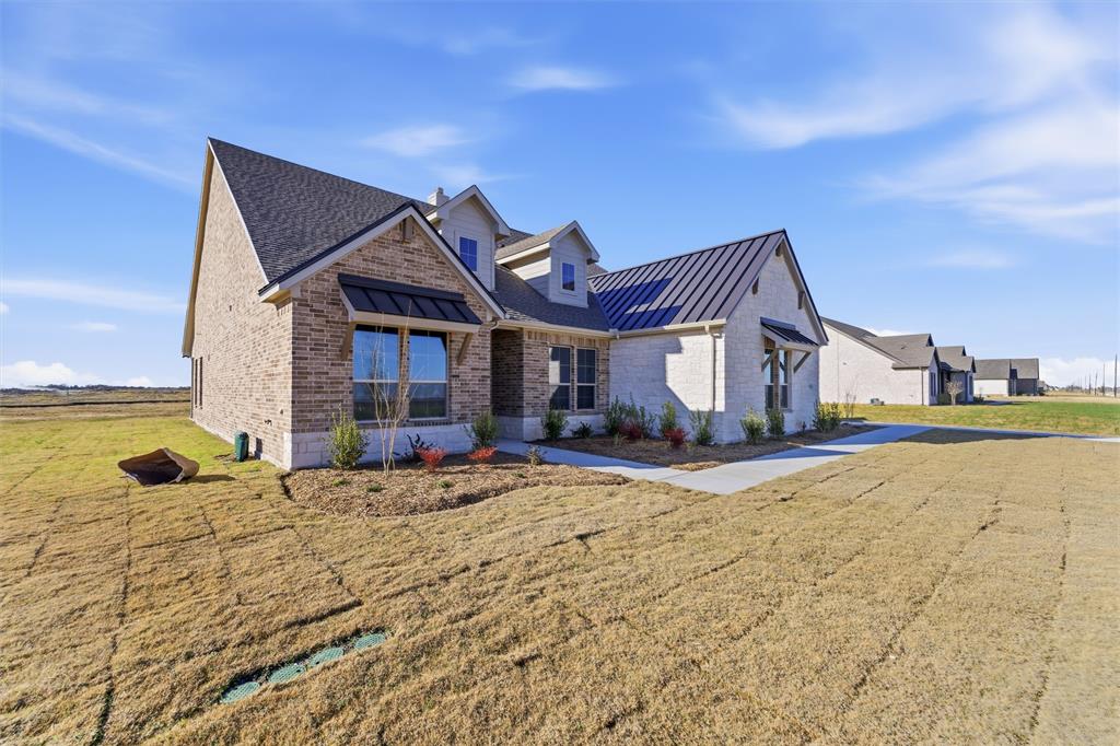 2050 County Road 200 Valley View, TX 76272 - Photo 4 of 31 View of front of home with a standing seam roof, a metal roof, a front yard, and brick siding