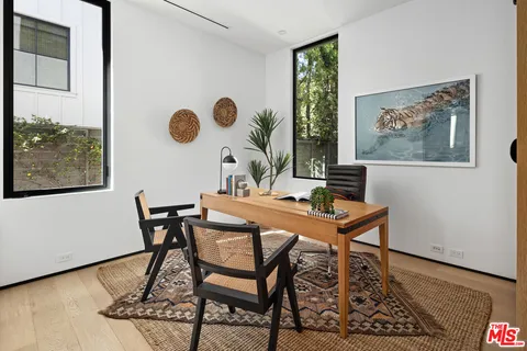 a dining room with table and chairs