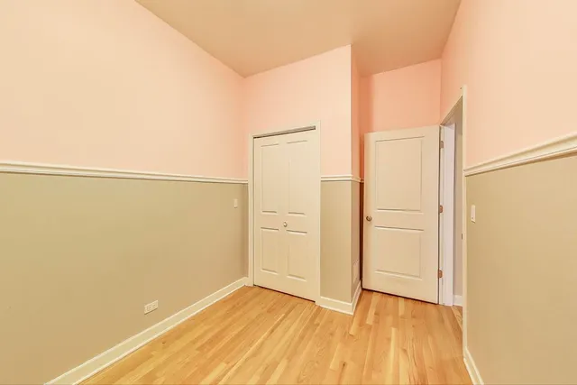 a view of a room with wooden floor